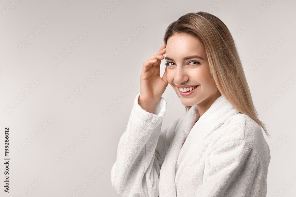 Beautiful young woman with silky skin on light background Beautiful young woman with silky skin on light background