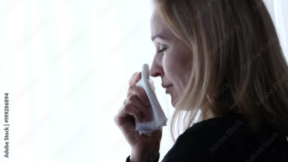 depressive woman near window is crying and thinking about something. 4K depressive woman near window is crying and thinking about something. 4K