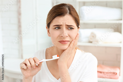 Photography Young woman suffering from toothache indoors
