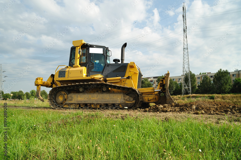 Crawler bulldozer. Lateral view of a crawler big bulldozer parcked on the river bed site. Crawler bulldozer. Lateral view of a crawler big bulldozer parcked on the river bed site.