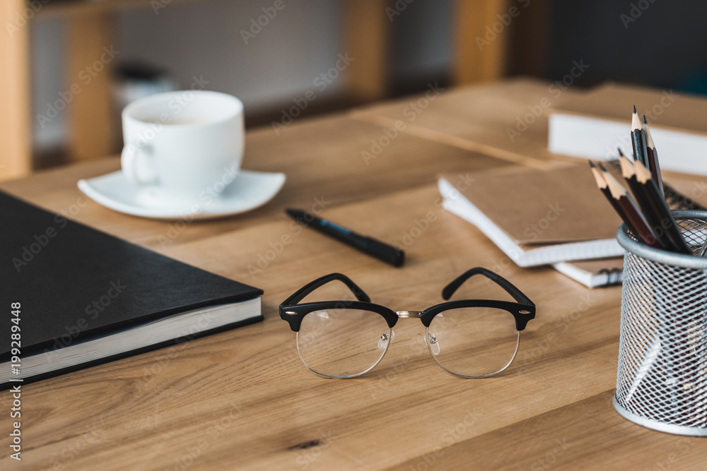 Close-up view of glasses on office table with stationery Close-up view of glasses on office table with stationery
