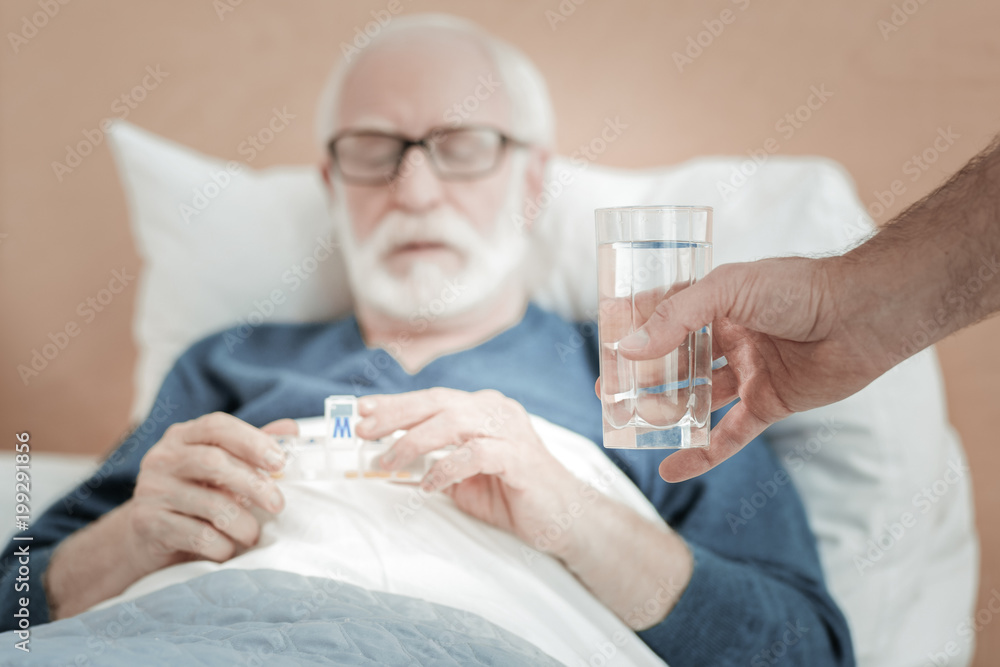 For you. A glass of fresh clean crystalline water being in mans hand. For you. A glass of fresh clean crystalline water being in mans hand.