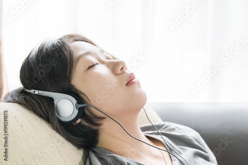 Young asian woman short hair listening music