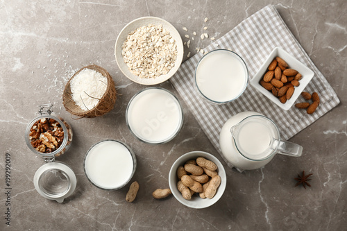 Composition with different types of milk and ingredients on light background