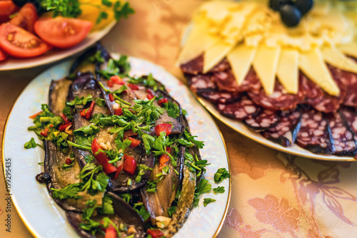 Pickled eggplant in plate on festive table photo