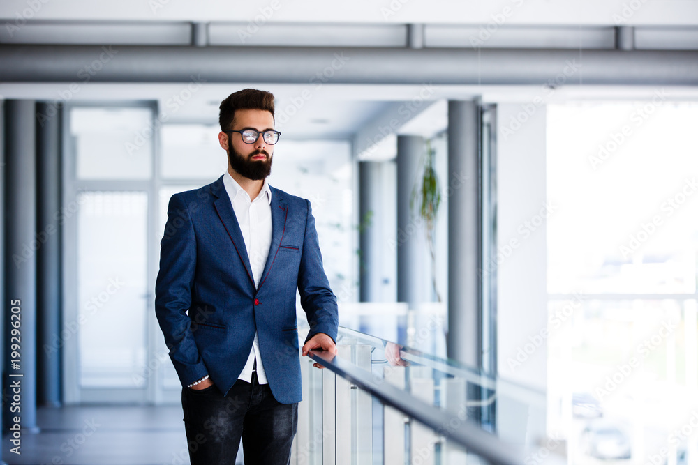 Young Handsome Businessman Standing At Company's Indoor Young Handsome Businessman Standing At Company's Indoor