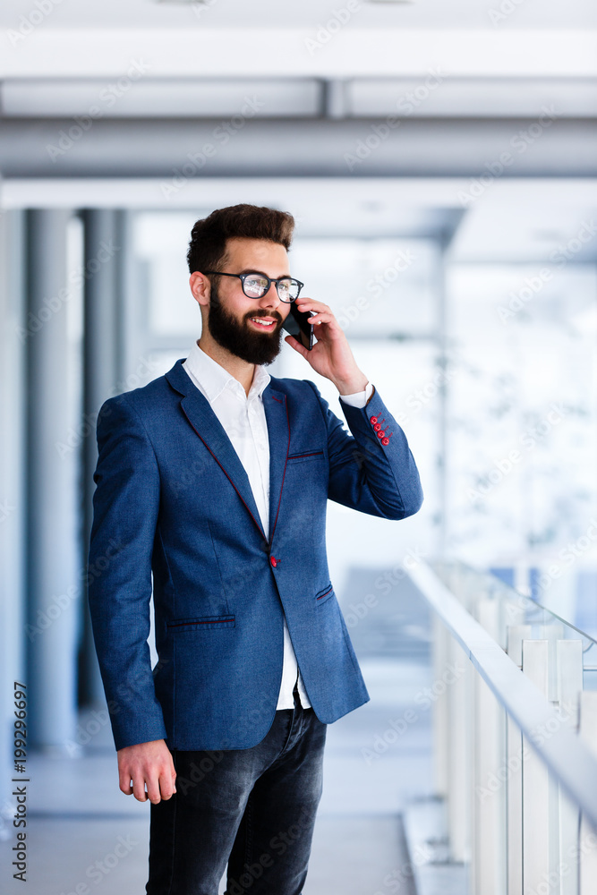 Young Banker Talking On Phone At Company's Indoor Young Banker Talking On Phone At Company's Indoor