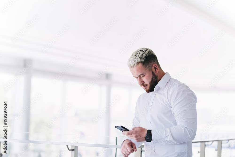 Young Handsome Businessman Using Smartphone At Break