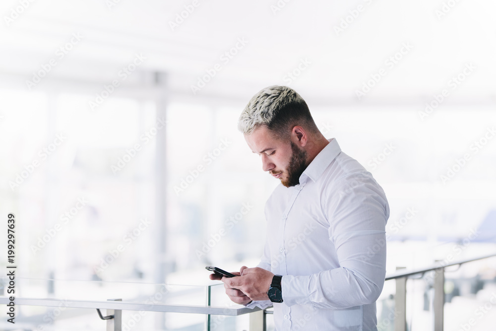 Young Modern Businessman Using Smartphone At Break