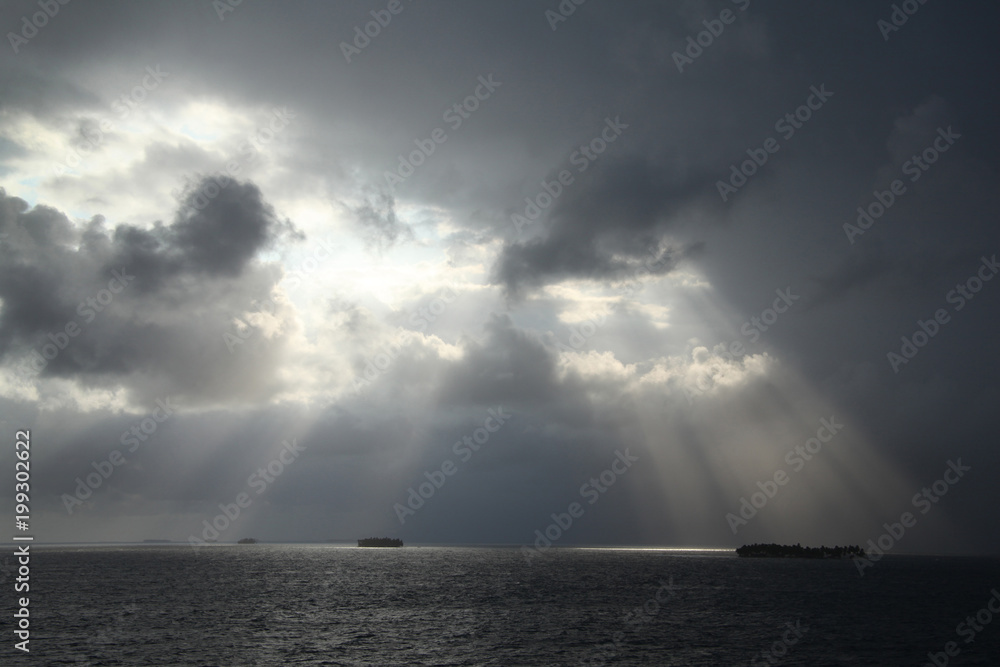 Sunlight shining through the clouds on the San Blas Islands, Panama, Caribbean.
