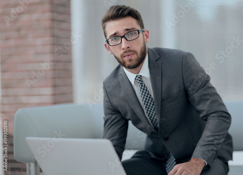 Portrait of a modern businessman sitting at his desk.