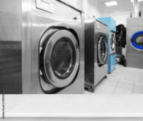 Industrial laundry washing machines in dry cleaner's workshop