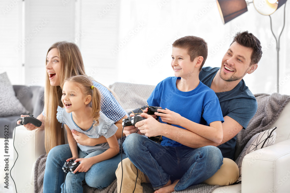 Happy family playing video games at home - obrazy, fototapety, plakaty 