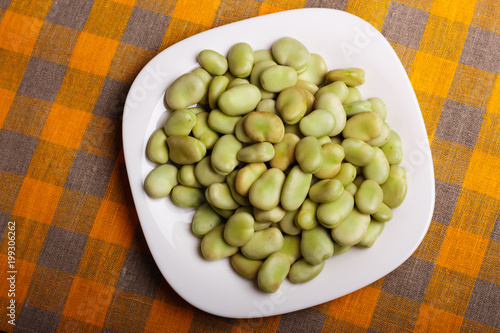 fresh broad beans on a rustic background