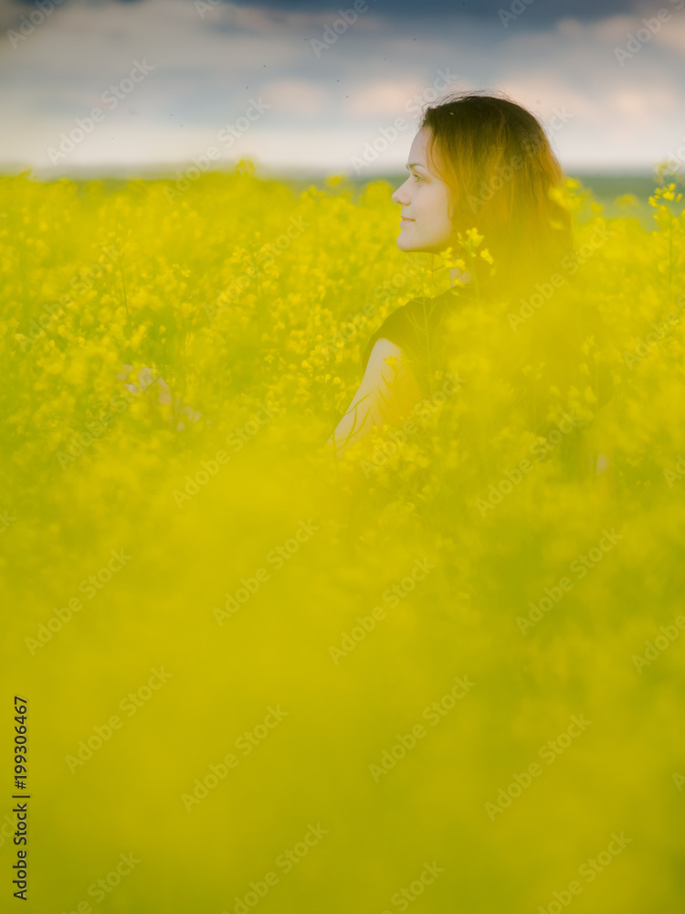 Fototapeta premium beautiful russian girl in a canola field