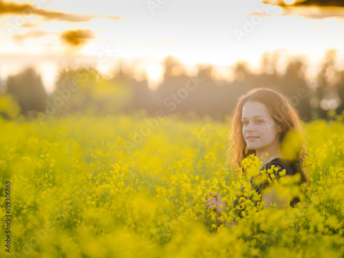beautiful russian girl in a canola field