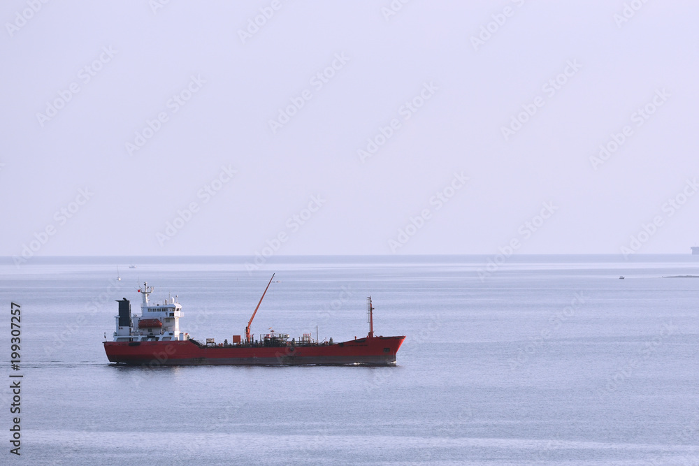 A ship tanker stands without traffic, a ship on a blue sky background