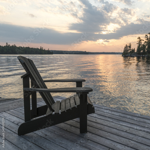 Adirondack chair on a dock, Kenora, Lake of The Woods, Ontario, Canada