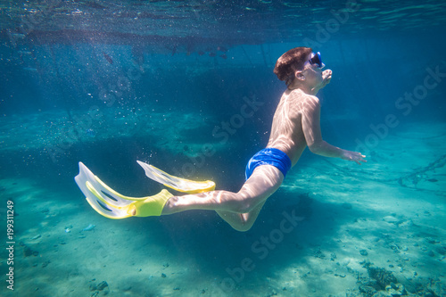 Boy dive in Red sea near pontoon