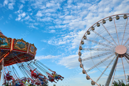 Ferris wheel and carousel in motion blur at Oktoberfest in Munich
