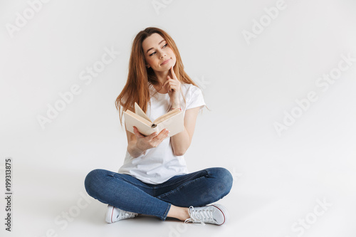 Portrait of a thoughtful young girl holding book