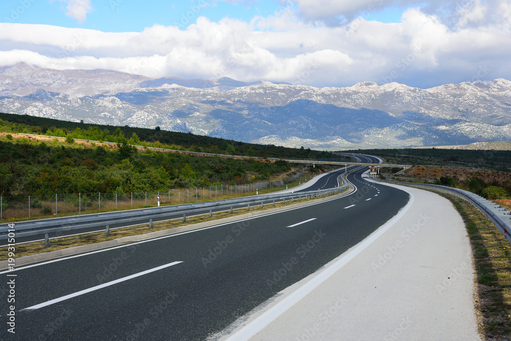 Croatian landscape with empty curved highway.  