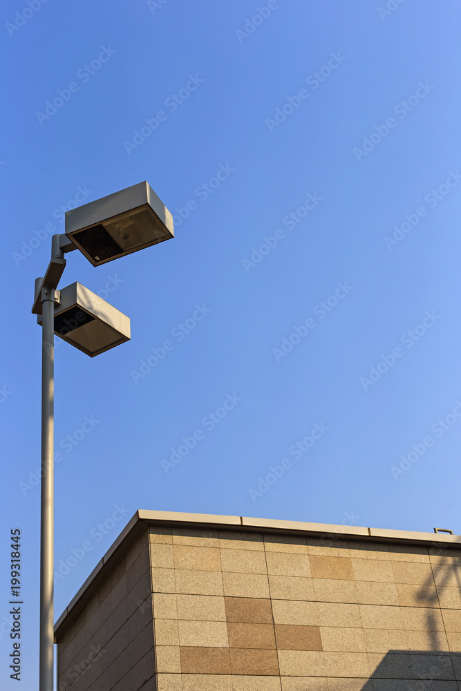 Part of the top of the building and lamp pole in the city. Part of the top of the building and lamp pole in the city.