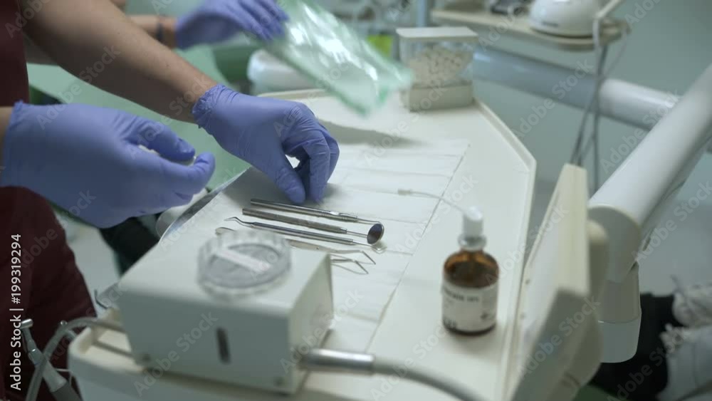 Hands arranging tools in a dental clinic