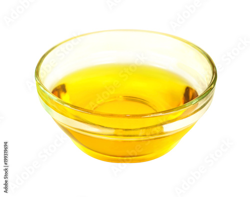 Tablou pe pânză Side view of vegetable transparent golden oil in glass bowl isolated on white ba