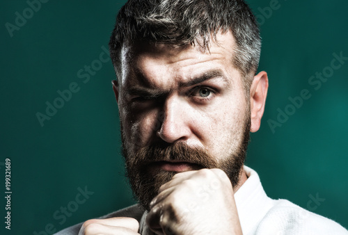 Portrait of bearded man in kimono, closeup. Bearded man dressed in kimono practicing aikido. Brutal bearded boxer, ready to fight. Boxing, workout, muscle, strength, power - sport concept. Copy space.