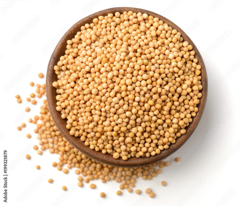 yellow mustard seeds in the wooden plate, isolated on white, top view yellow mustard seeds in the wooden plate, isolated on white, top view