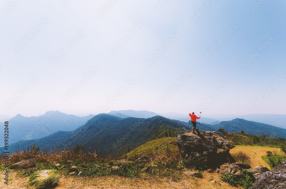 people selfie on the rock on mountain nature landscape with blue sky.