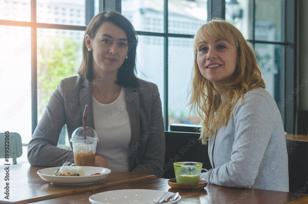 portrait of two attractive young women meeting in coffee shop. portrait of two attractive young women meeting in coffee shop.