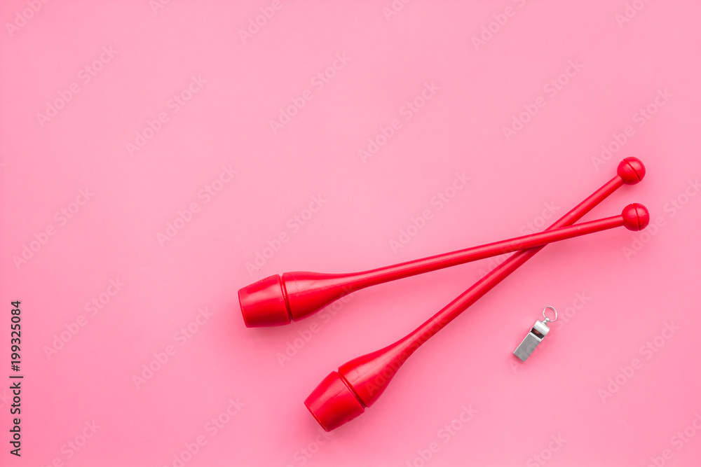 Maces for rhythmic gymnastics on pink background top view copy space Maces for rhythmic gymnastics on pink background top view copy space
