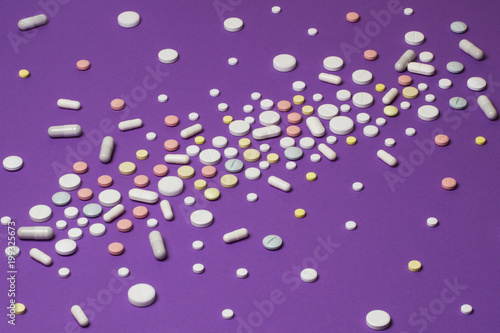 Tablets scattered on a violet background.