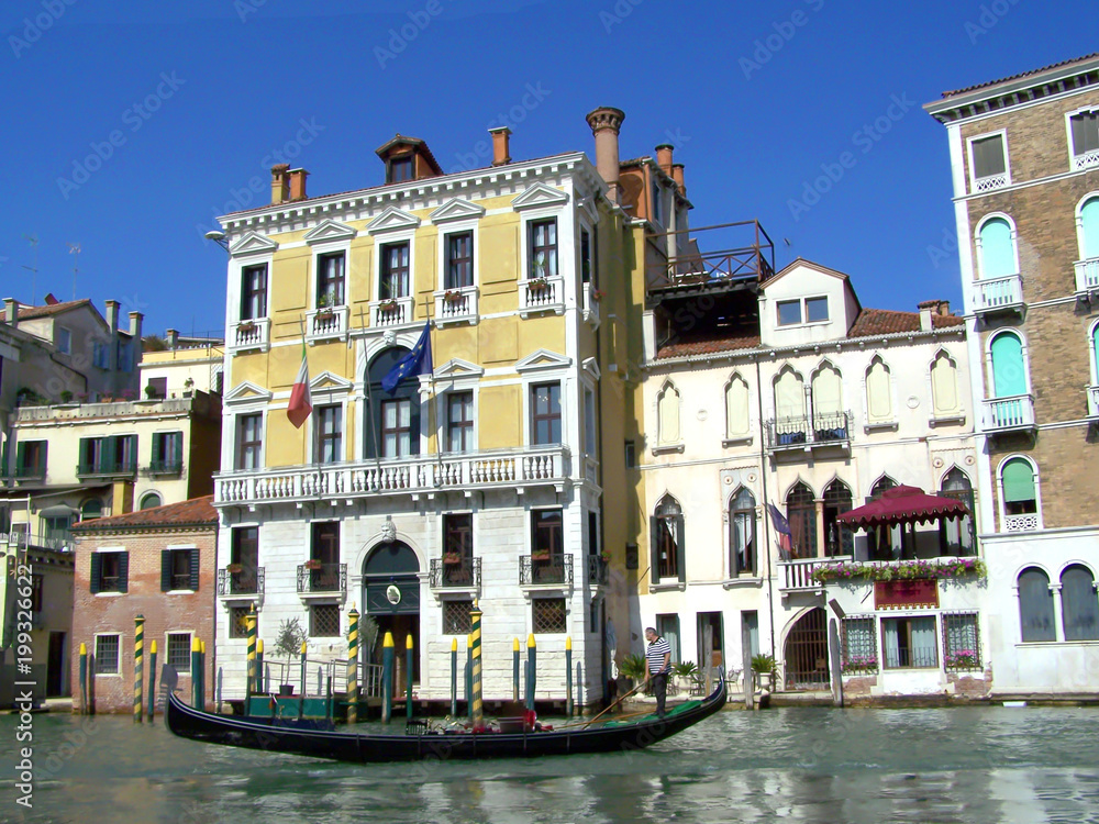 Gondola on the canal in Venice on a beautiful sunny day