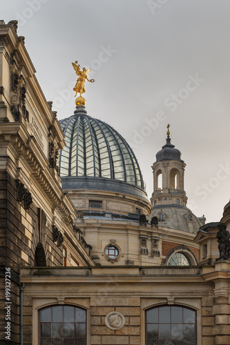 Golden Angel on Rooftop in Historic Context, shone on by the sun