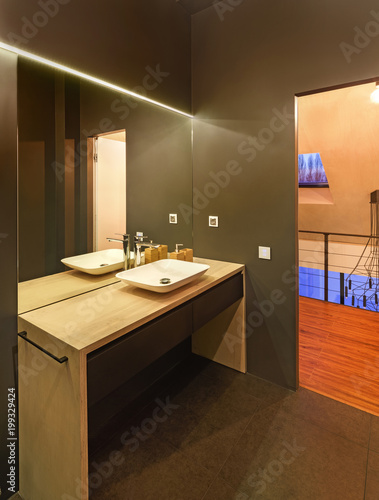 bathroom interior with a washstand; toilet bowl; bath and shower