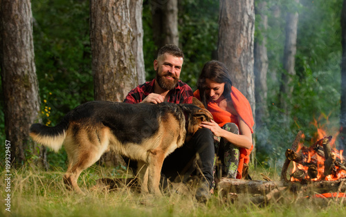Woman and man on vacation, hiking, camping. Family pet concept.
