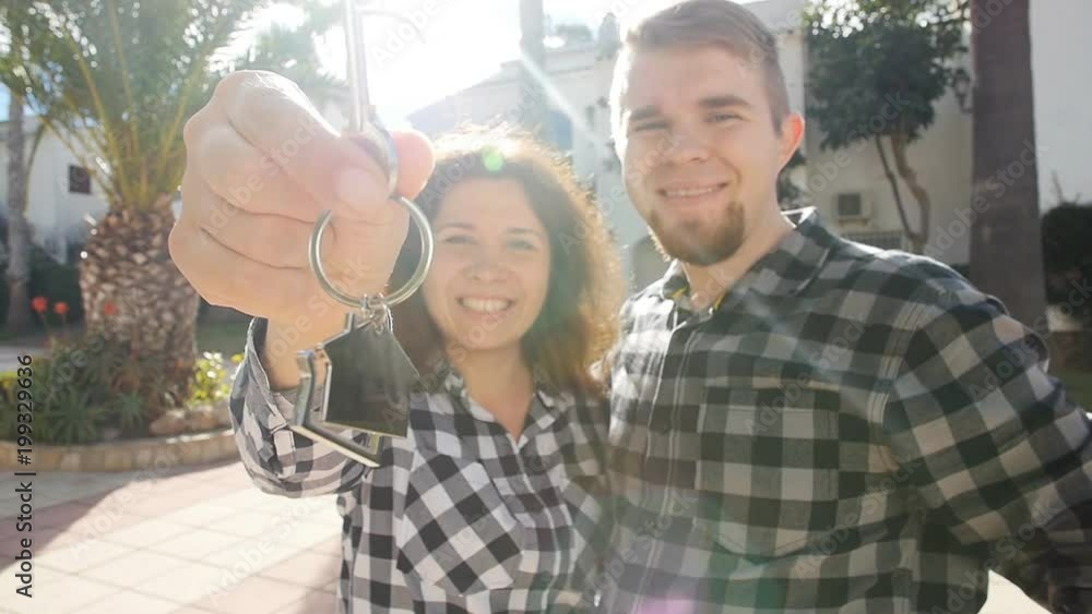 Happy couple homeowners with key. Real estate, new house or apartment and people concept Happy couple homeowners with key. Real estate, new house or apartment and people concept