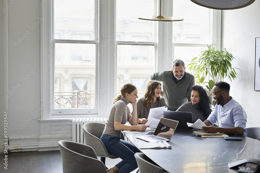© Cavan Images - Business people discussing in meeting at office