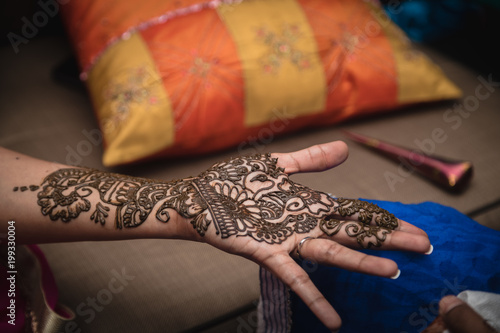 Fresh bridal henna tattoo. Bridal Indian henna design on woman's hand.