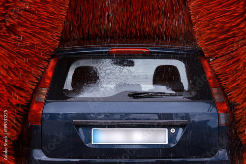 A car inside a car washing machine while it is working