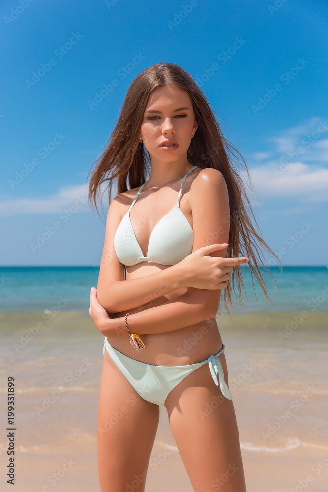 Fashion portrait of a beautiful young sexy woman. Dressed white swimsuit,  tanned skin, body. Vogue style foto de Stock | Adobe Stock