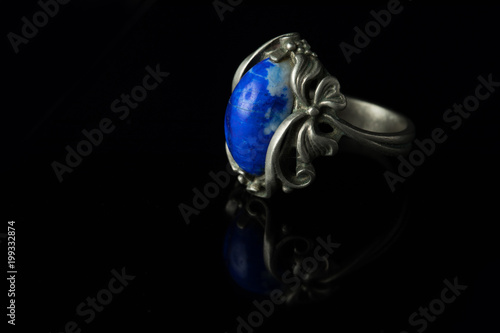 Silver ring with lapis lazuli on a black background