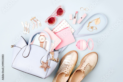 Set of Feminine accessories  with handbag, watch, note, beauty products and shoes. Flat lay, top view. Fashion concept in pastel colored photo