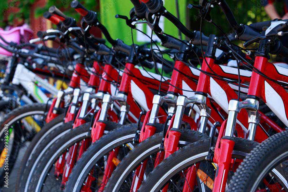 many bicycles stand in a row many bicycles stand in a row