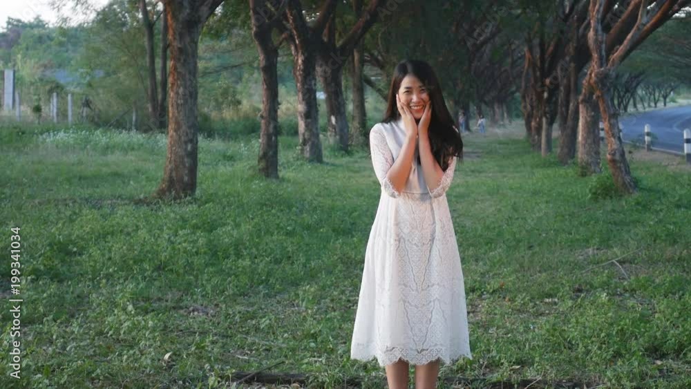 Slow motion of beautiful woman standing in the park Slow motion of beautiful woman standing in the park