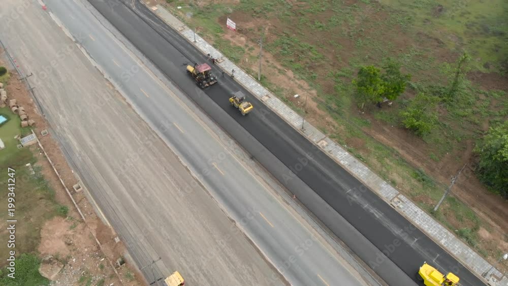 Asphalt machine and steamroller operator job at new road construction site Asphalt machine and steamroller operator job at new road construction site