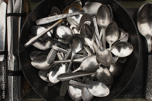 background of old silver spoons on the market